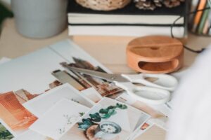 table with various photos and scissors